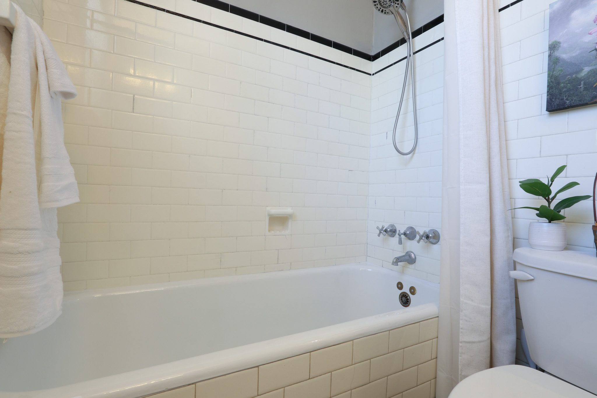 Bathroom with tub and tile surround